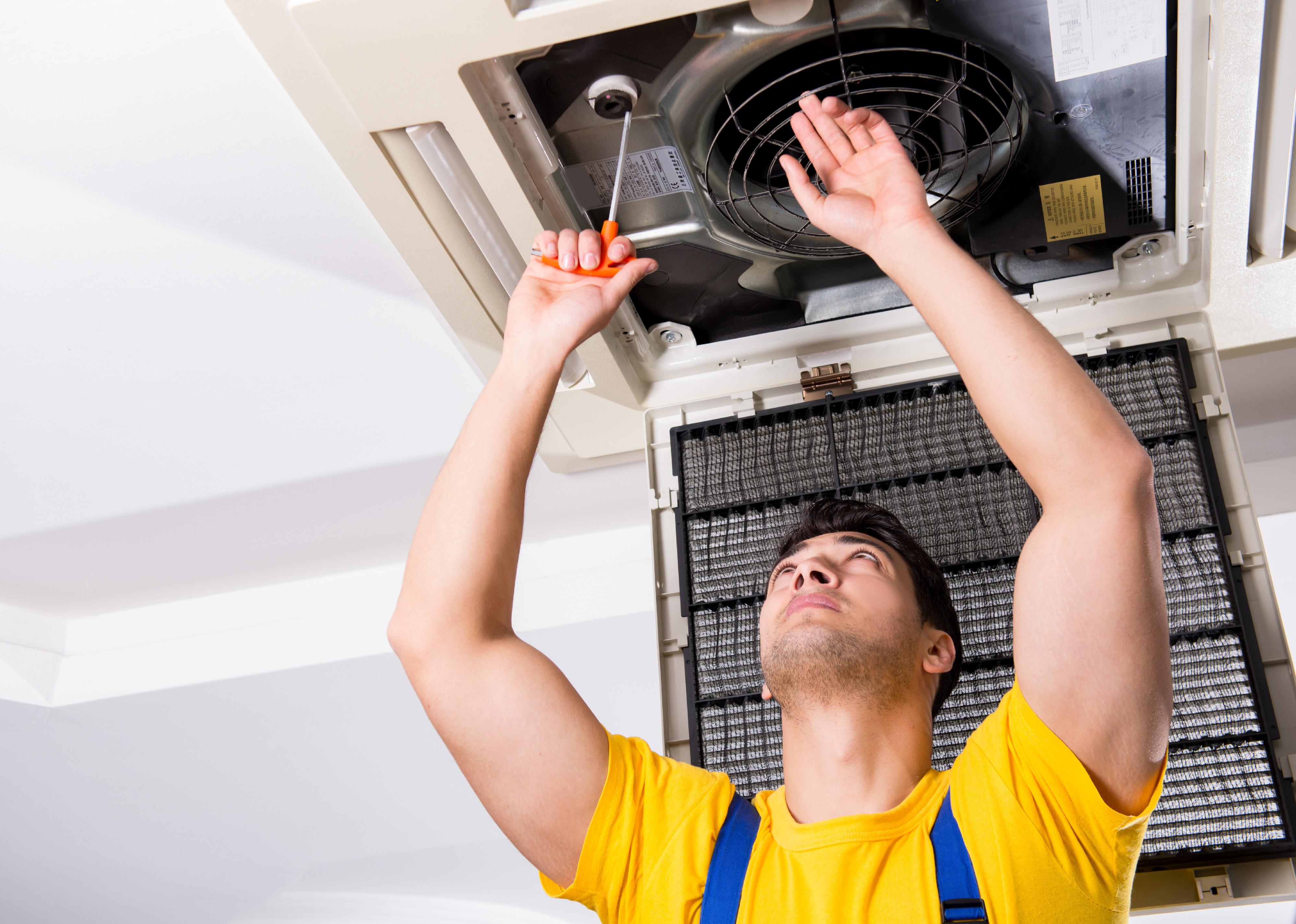 A contractor inspects a home's HVAC unit