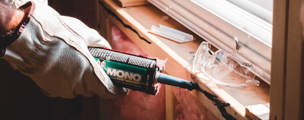 A contractor makes emergency repairs to an interior wall and window in a rental property