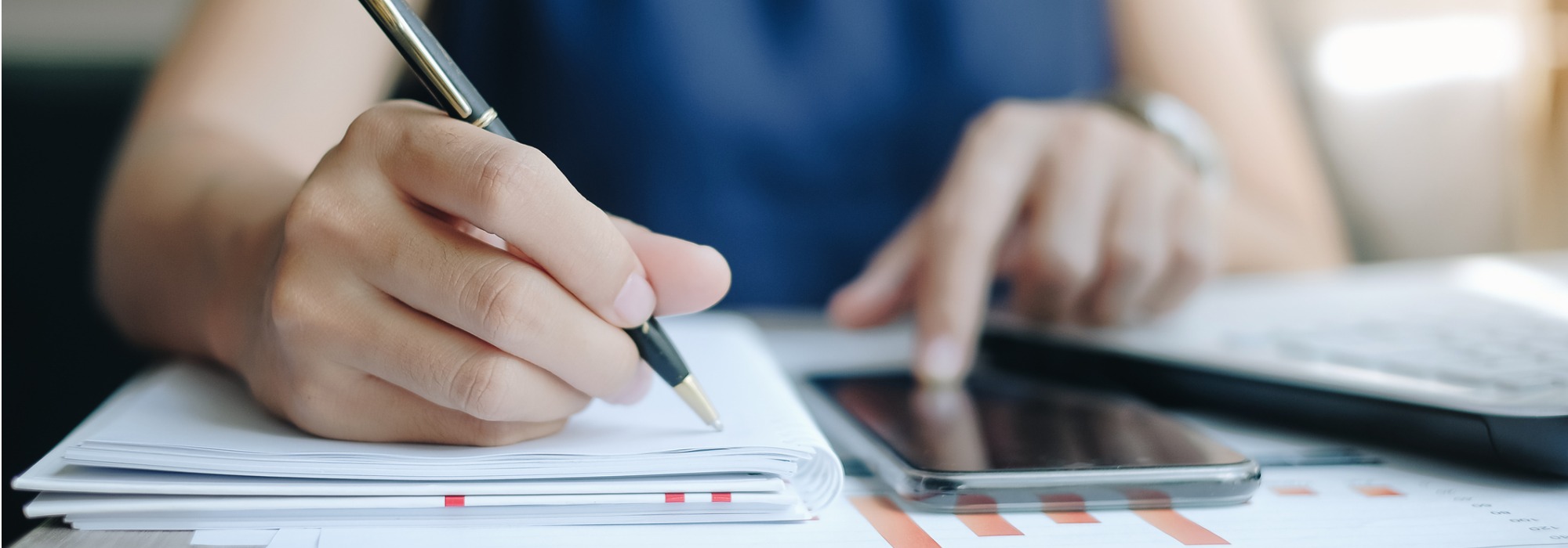 Woman using a tax calculator to assess real estate income from rental