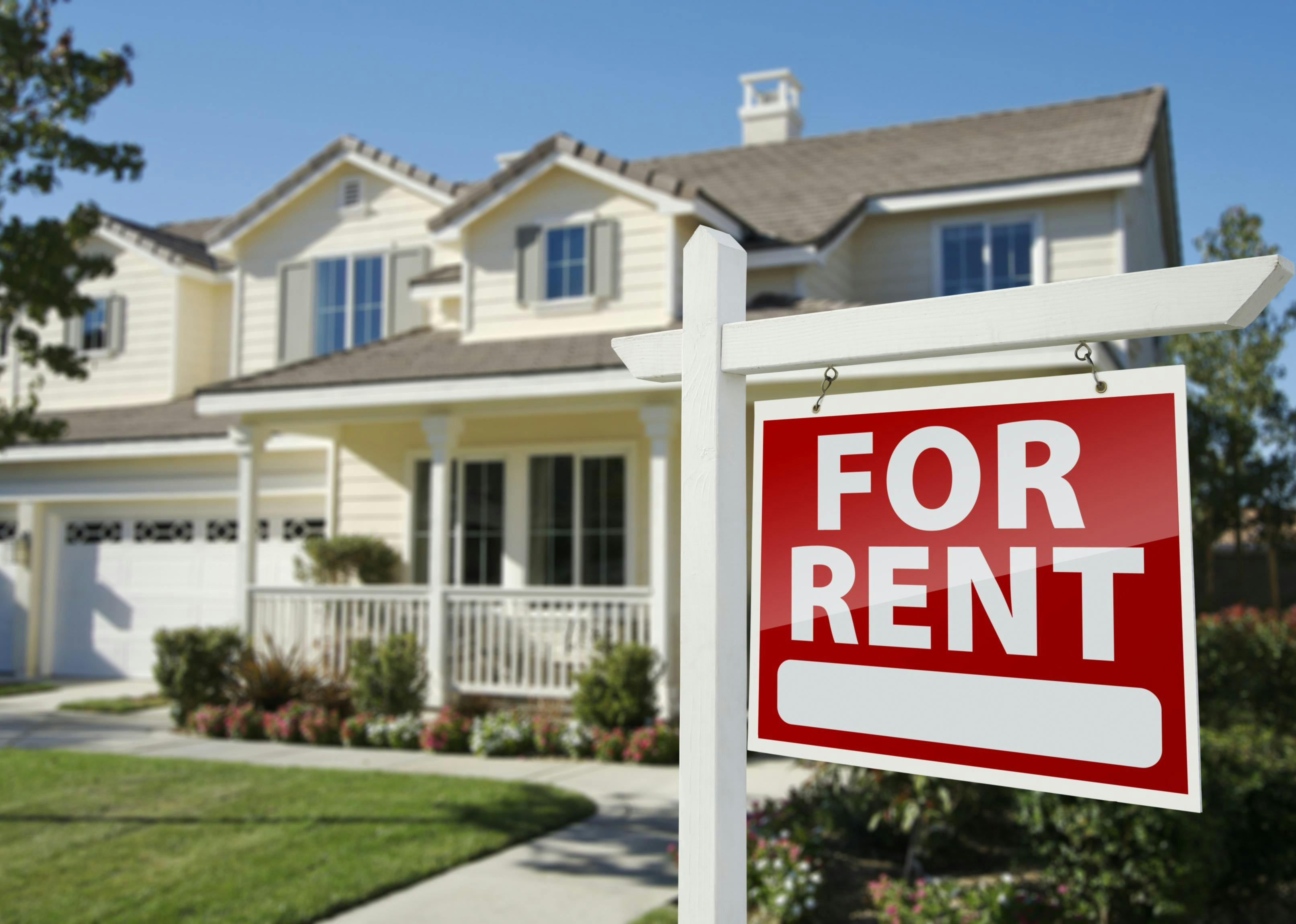 An image of a single-family home with a "for rent" signpost in the yard