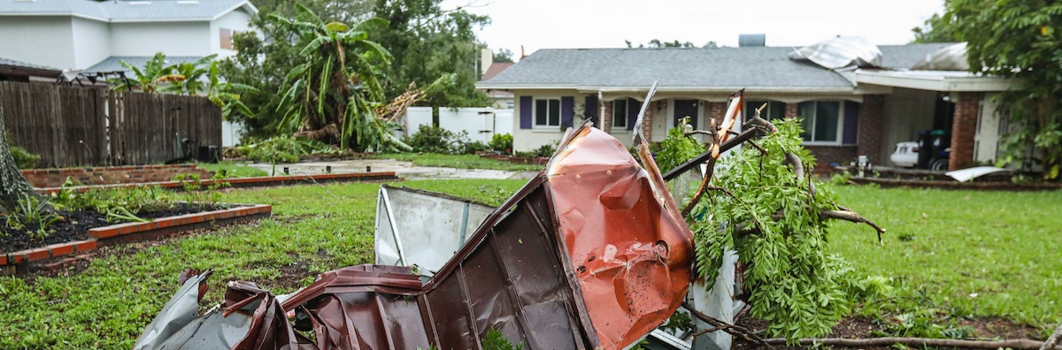 A Florida home with storm damage in the front yard