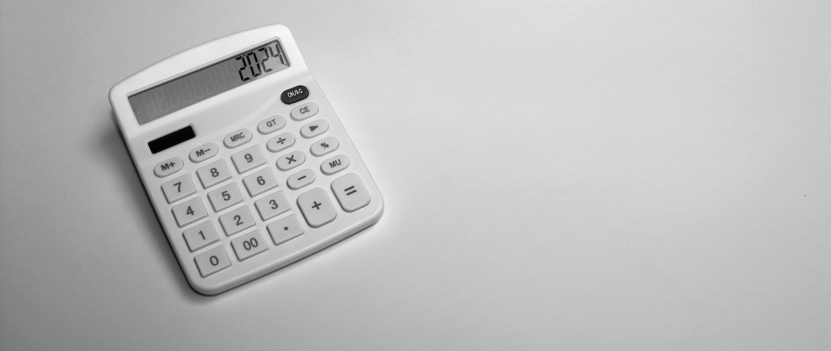 A white calculator on a white background reads '2024', representing rental home finances in the year 2024