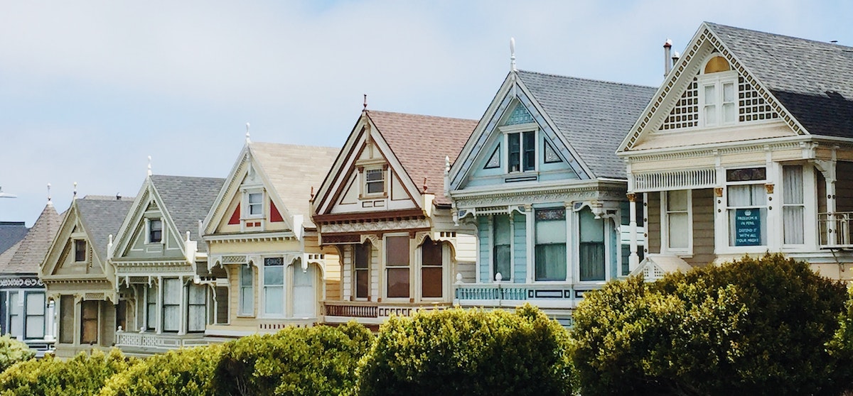 A row of iconic, colorful homes in San Francisco's Bay Area. Learn more about investing in the SF Bay Area. 