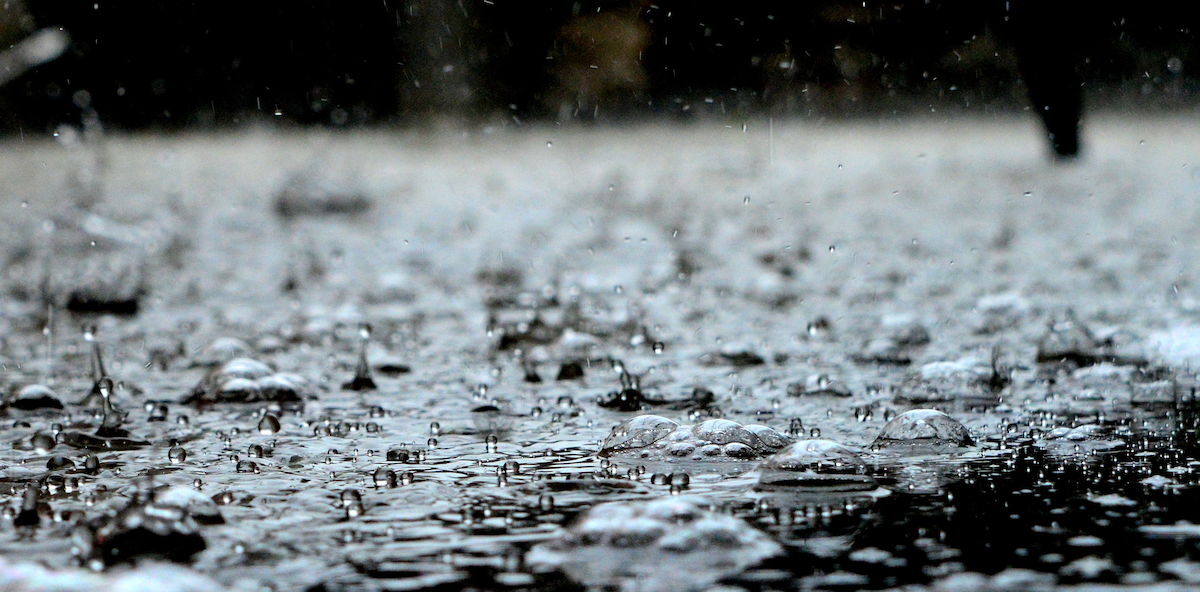 A close-up shot of heavy rainfall, a common cause of flooding in rental homes