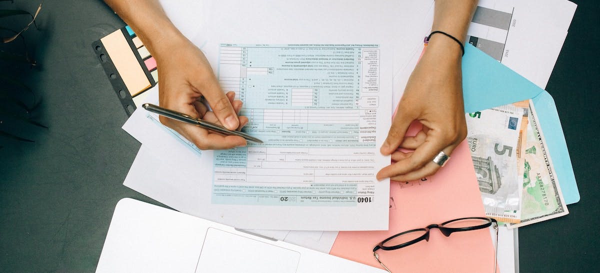An overhead shot of someone completing a tax return, including working out the tax rates on rental income in the US