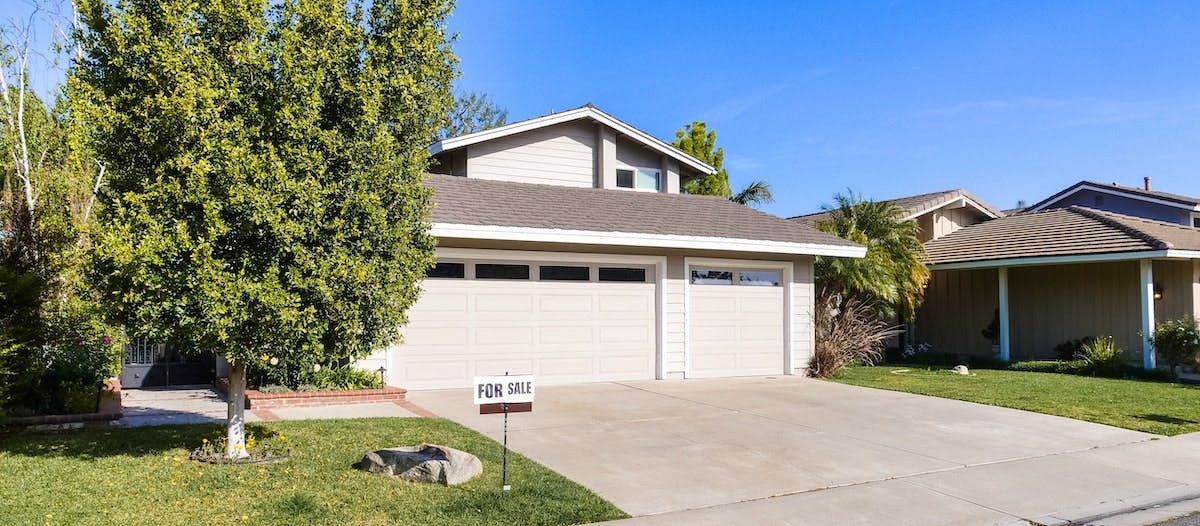 A photo of a single-family home for sale. If you're considering a real estate investment, find out what you need both an asset manager and property manager to maximize income and returns. 