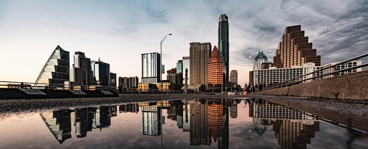 A photo of the skyline in Austin. Texas, reflected in water at dusk
