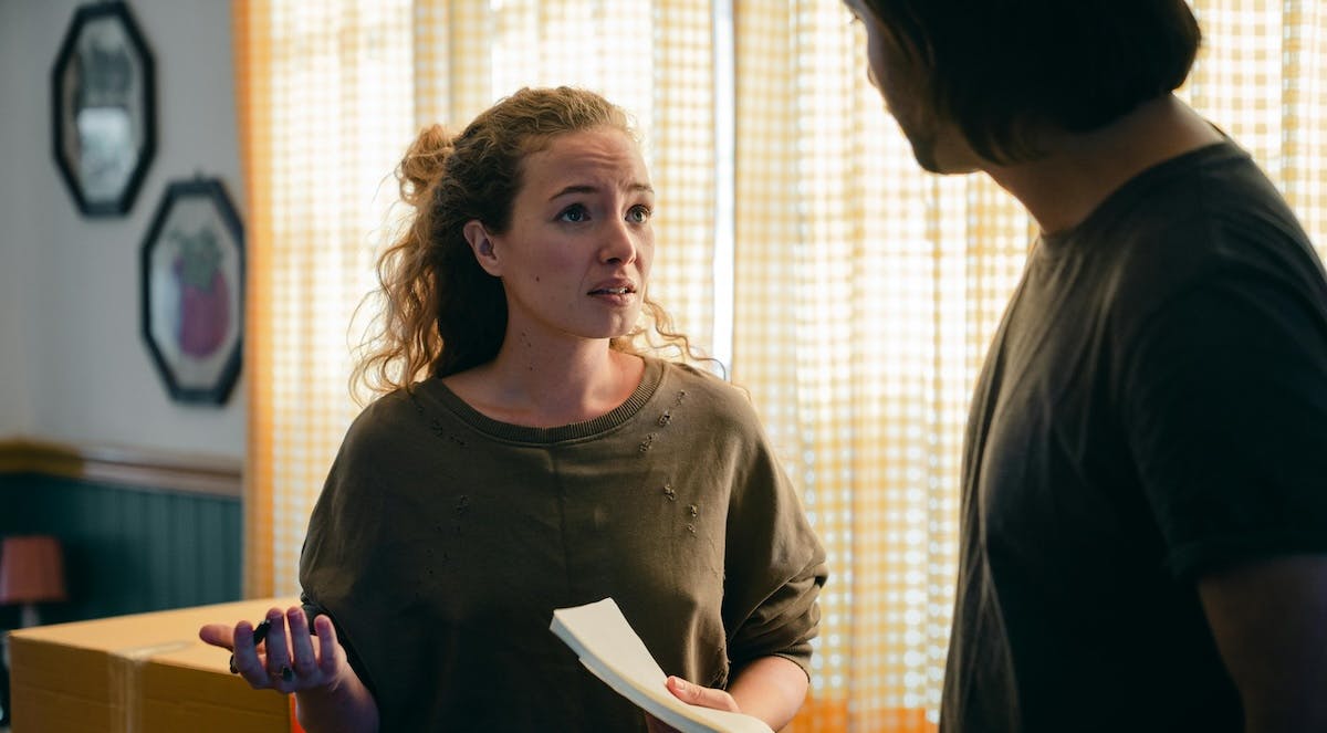 A woman showing concern while moving in to a new rental