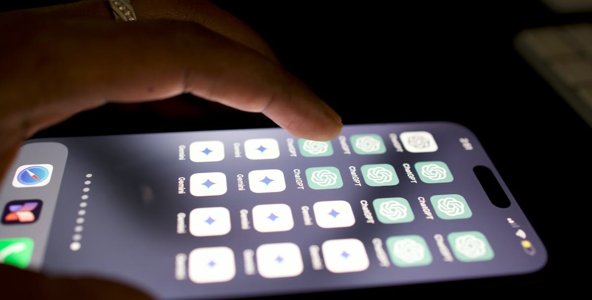 An iphone shows a home screen with AI apps ChatGPT and Google Gemini