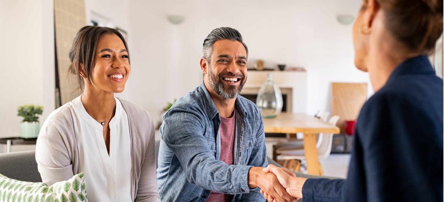 Happy couple choosing a new property manager to work with for their rental home