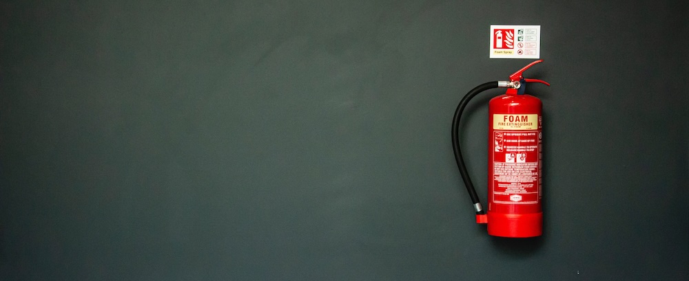 A photo of a fire extinguisher, which could help put out spot fires in a rental property 