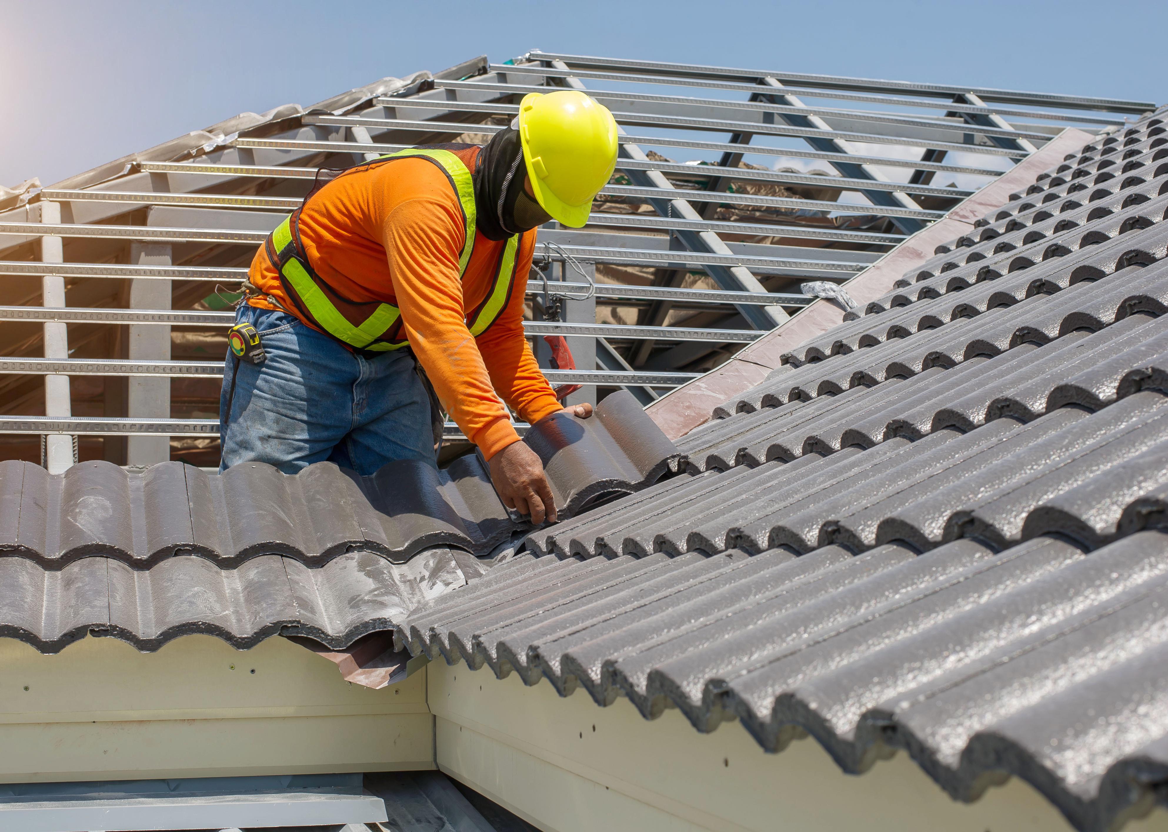 A residential construction work replaces the roofing on a home