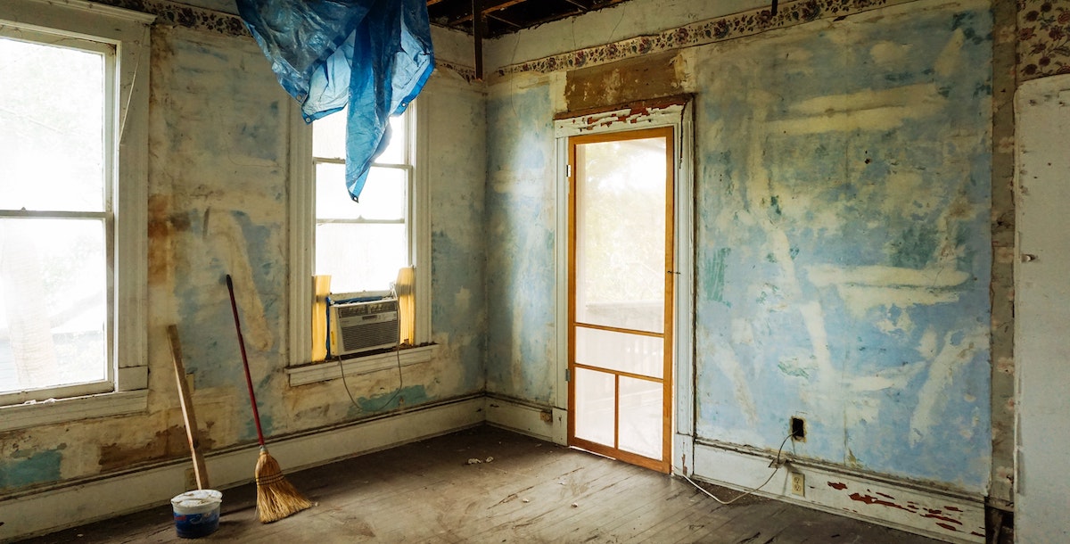 An image of a run-down home in need of a full renovation. Homes in poor condition can be flipped for a profit, or you could renovate to rent for longer-term passive income. 