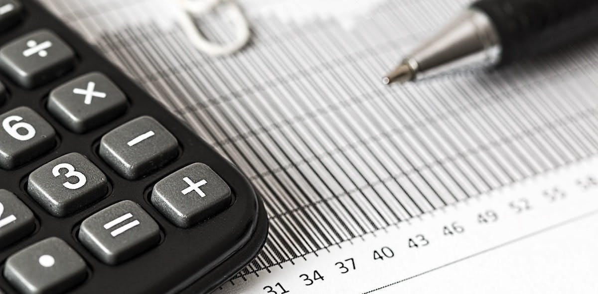 An image of a calculator and sheet tracking investment yields over time. Learn more about The Rule of 72 in relation to real estate investment. 