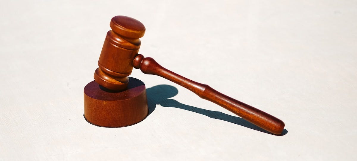 An image of a brown gavel on a white background, depicting the legal eviction process in California