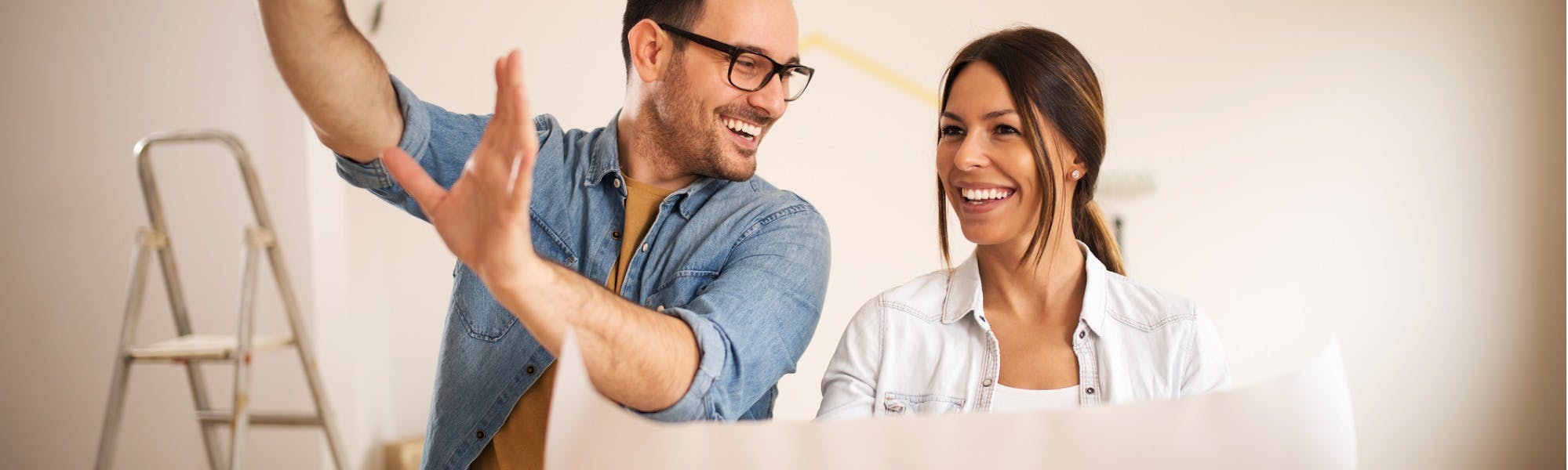 Happy couple planning a renovation of their rental home with no shortage of contractors to complete work