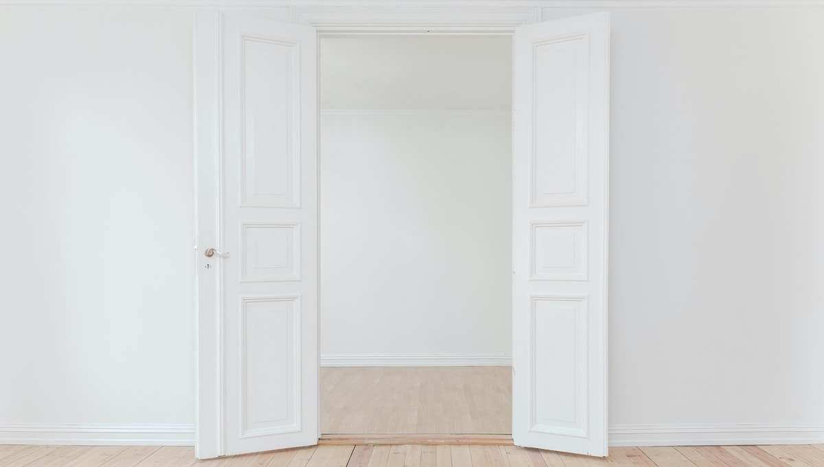 A photo of an empty rental home with a fresh white painted door, a rental home ready for new long-term tenants