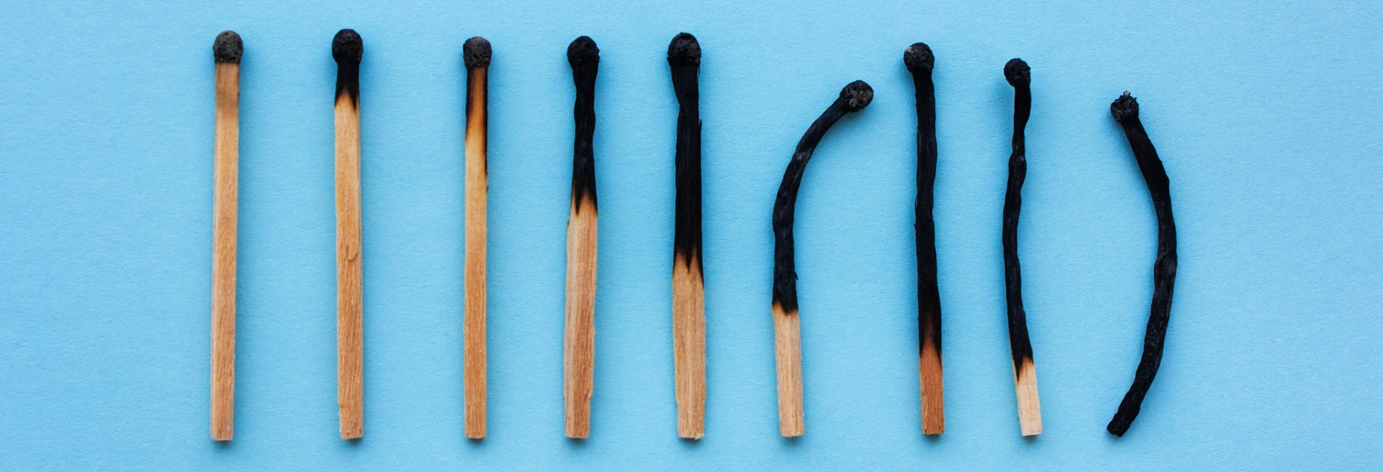 A series of matchsticks, progressively more burnt. Image depicts stress and burnout of managing a rental property. 