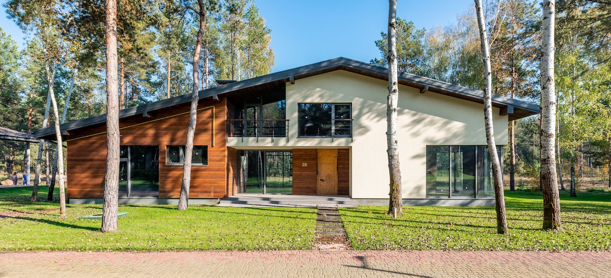 An image of a single family home surrounded by large trees. Find out how to spot the difference between a buyers market and sellers market in your local real estate market. 