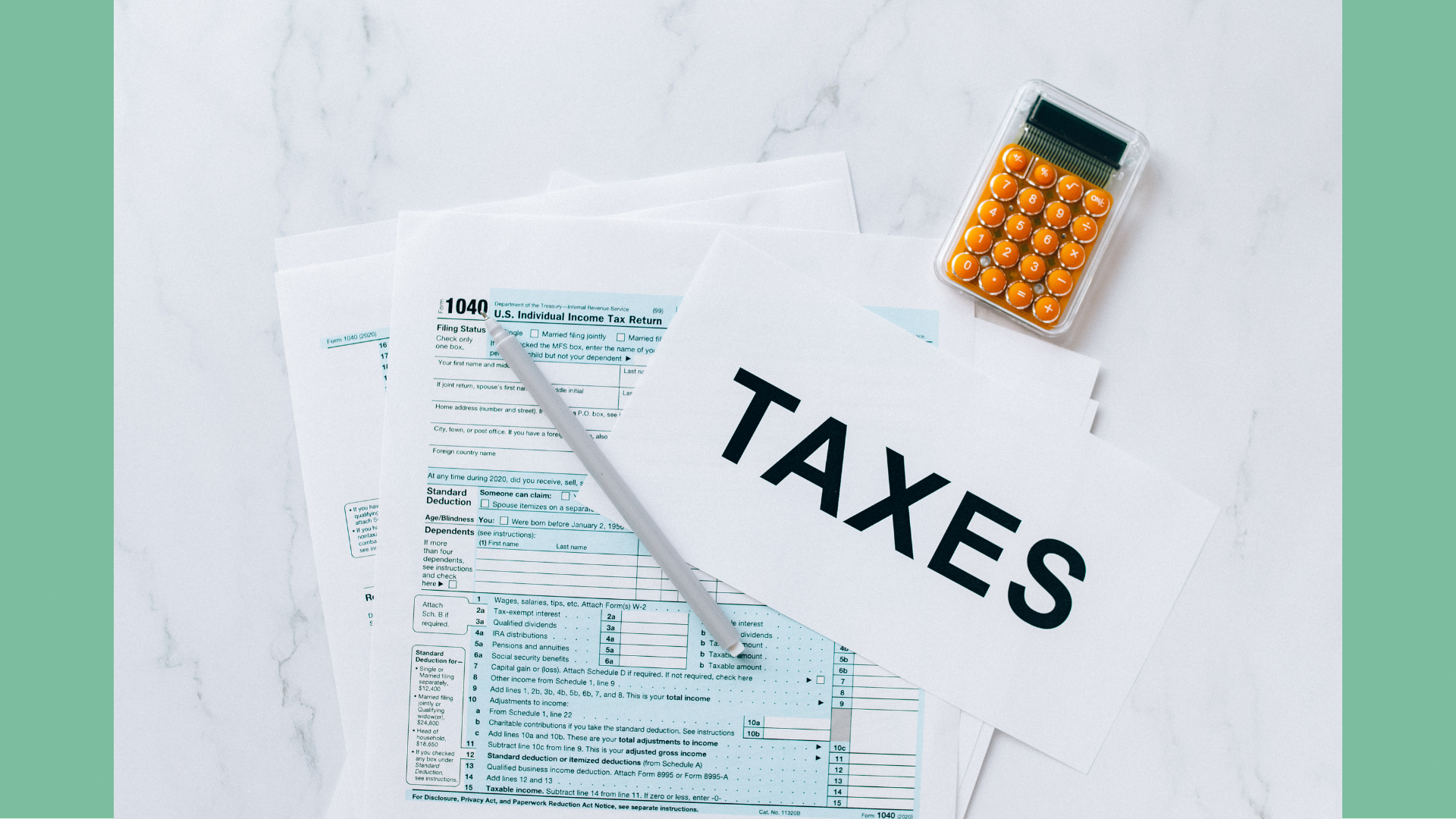 A flatlay image of taxation paperwork and a calculator with a sign that reads "TAXES", depicting tax season for landlords