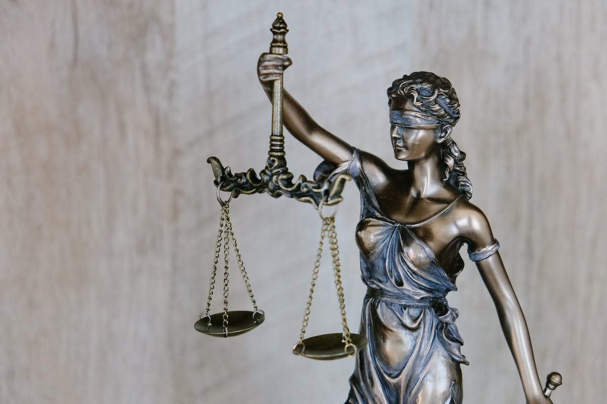 A photo showing a statue of "Lady Justice", a symbol of the US legal system, as discussed in this article on criminal activity in rental homes. 