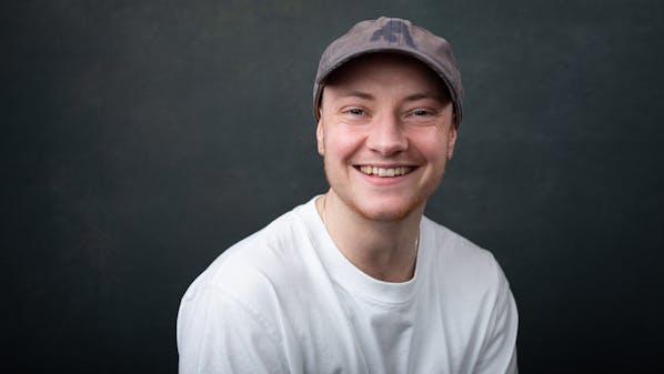 a headshot of a London actor smiling