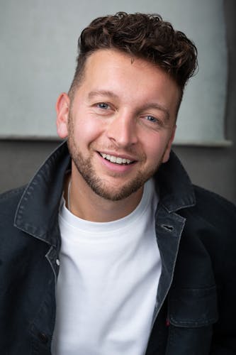 a London actor smiling in a headshot