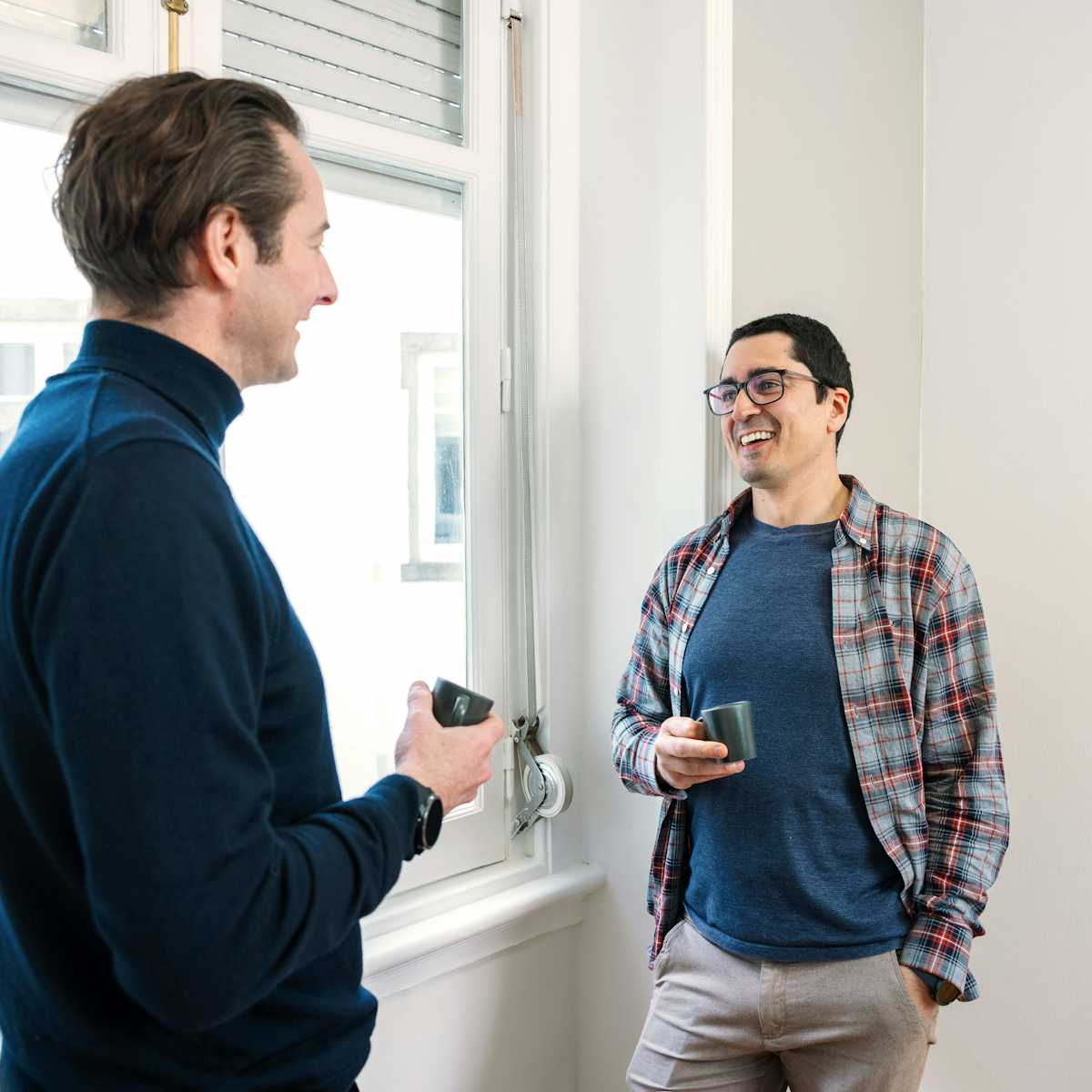 A photo of 2 people talking.