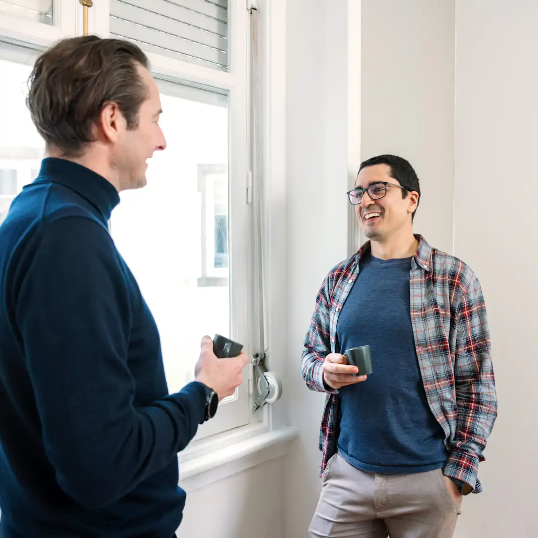 A photo of 2 people talking.