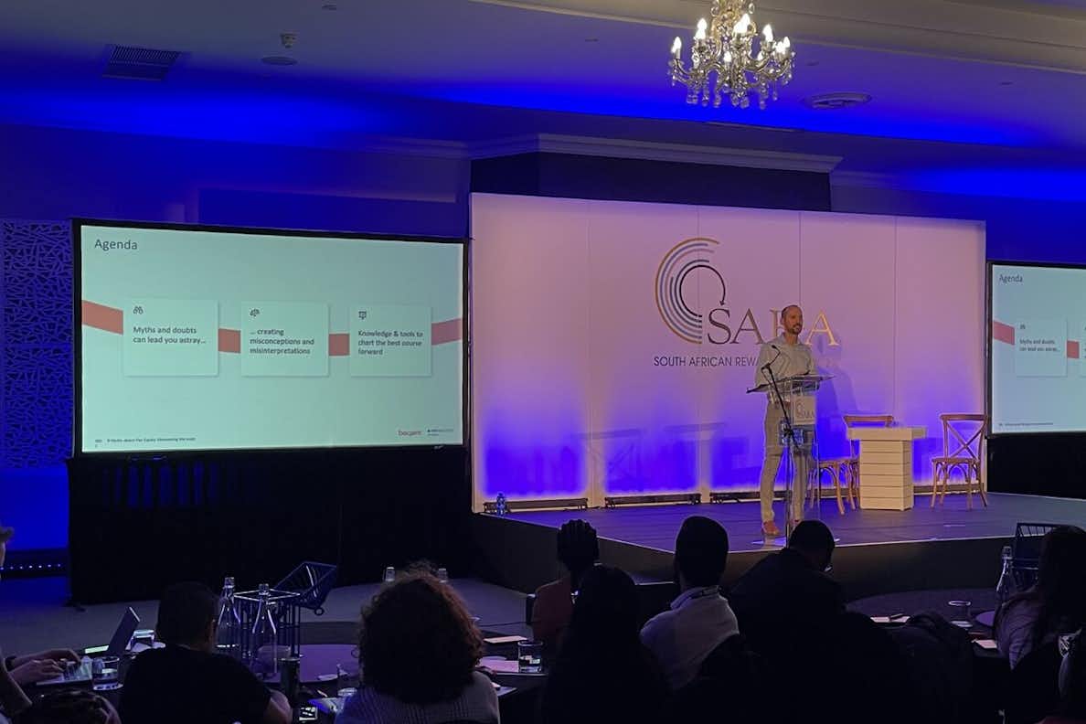 Person giving a keynote presentation at a conference.