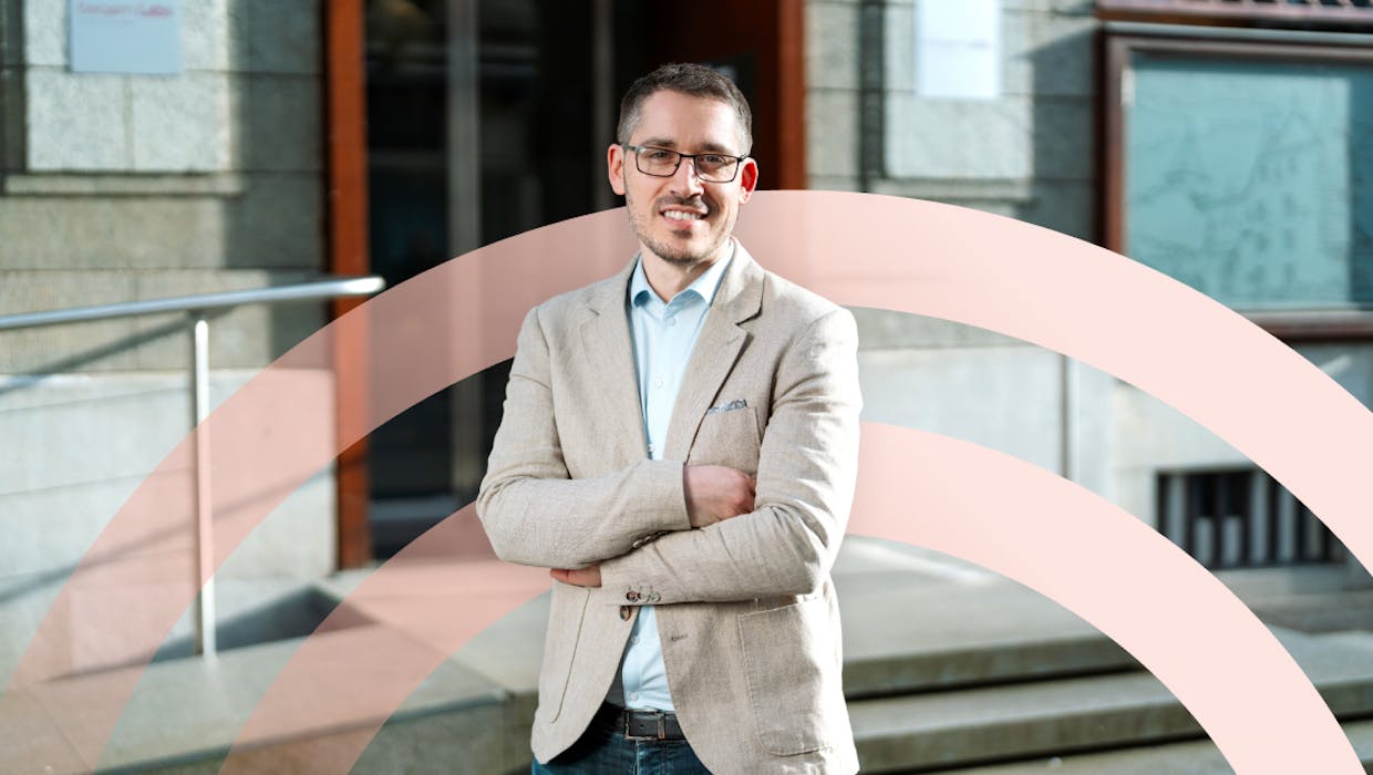 happy employee with arms crossed in front of the office location