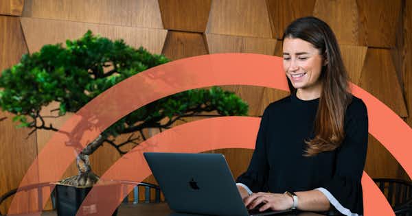 Woman sitting at a computer and smiling