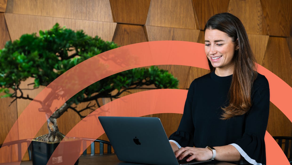 Woman sitting at a computer and smiling