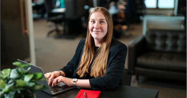 Woman sitting in an office with a computer.