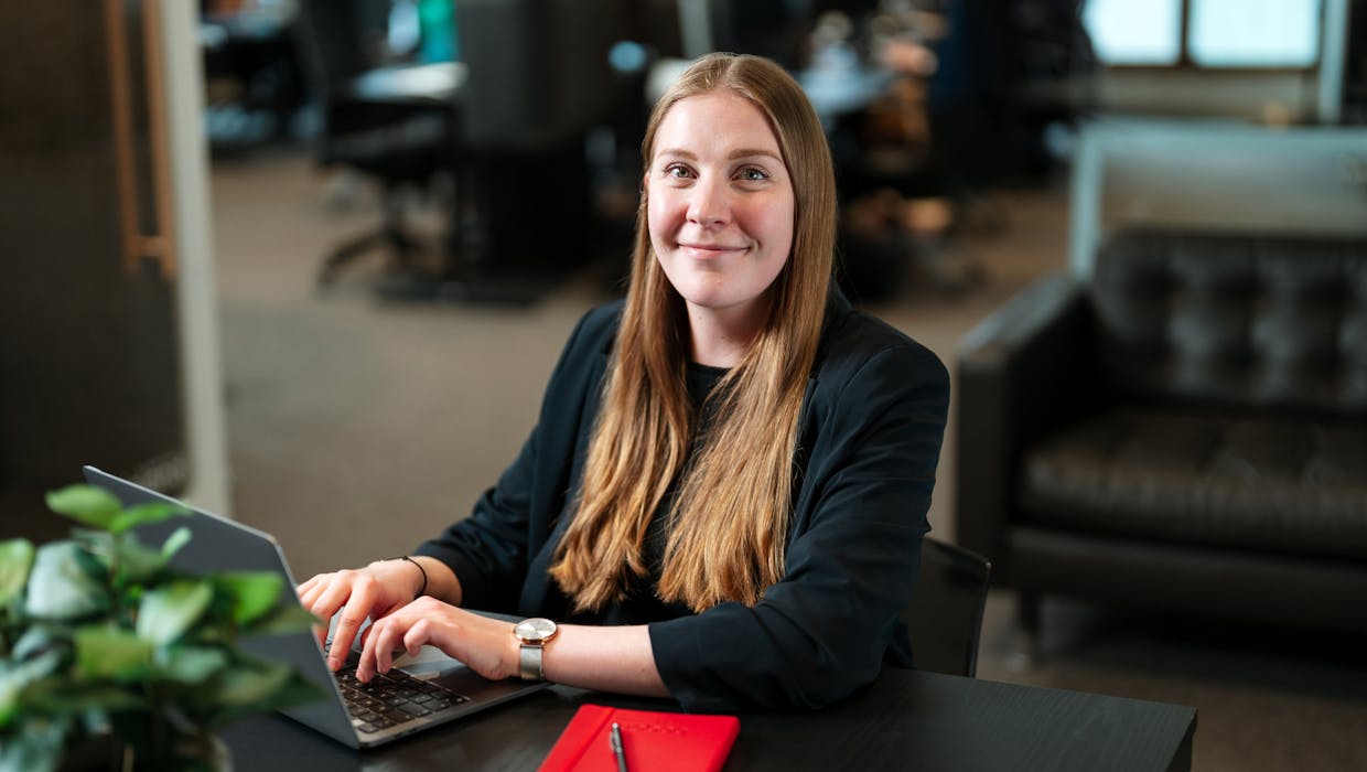 Woman sitting in an office with a computer.