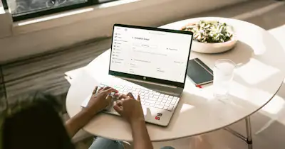 person typing on laptop on table