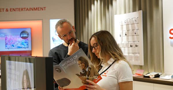 Man and woman in office setting looking at Sunrise brochure
