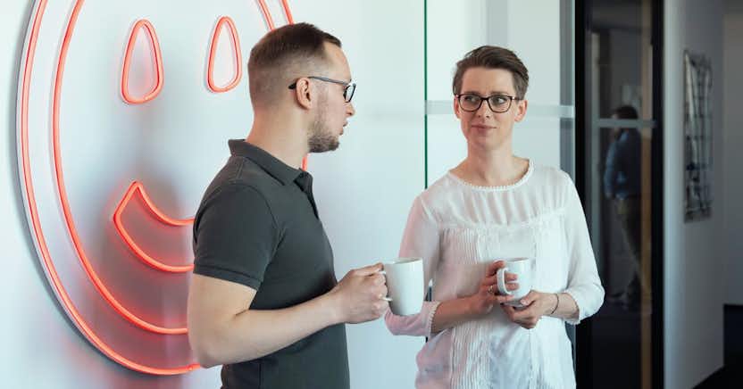 Woman and man talking together in an office setting