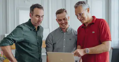 Male employees looking at computer