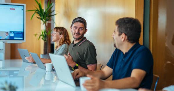 Employees working together at a table.
