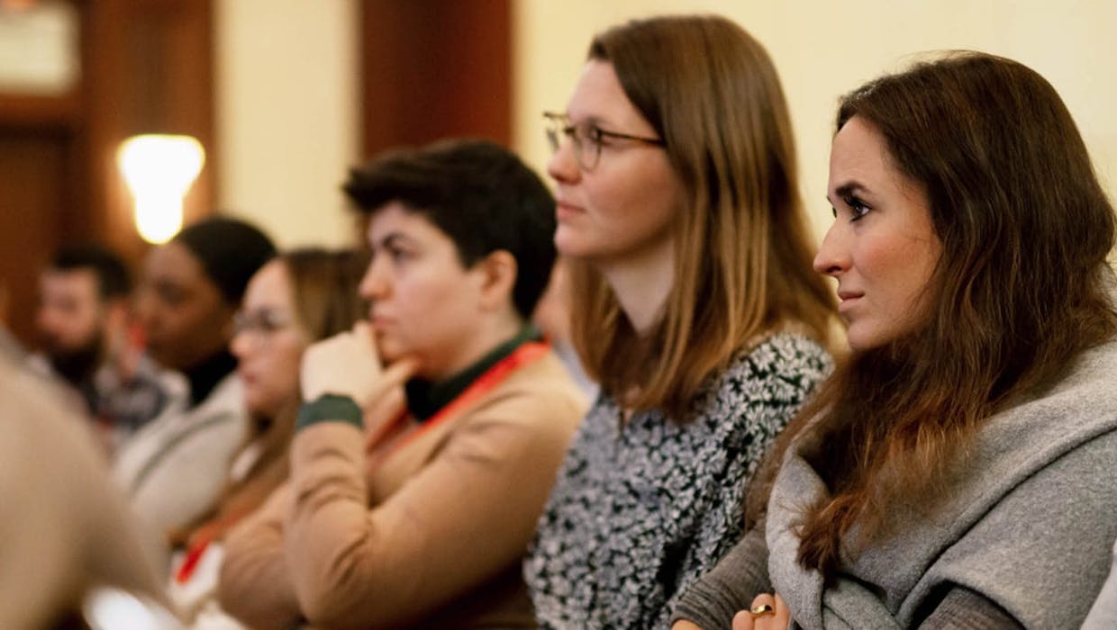 Female and male employees seated in a meeting room