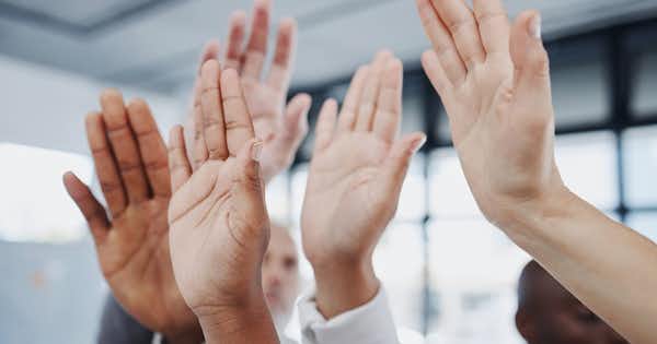 5 raised hands with different skin tones