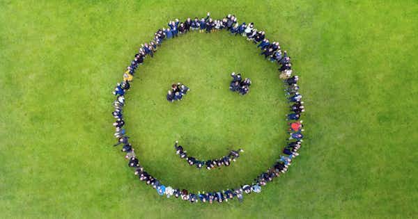 A smiley face formed by people and photographed from above