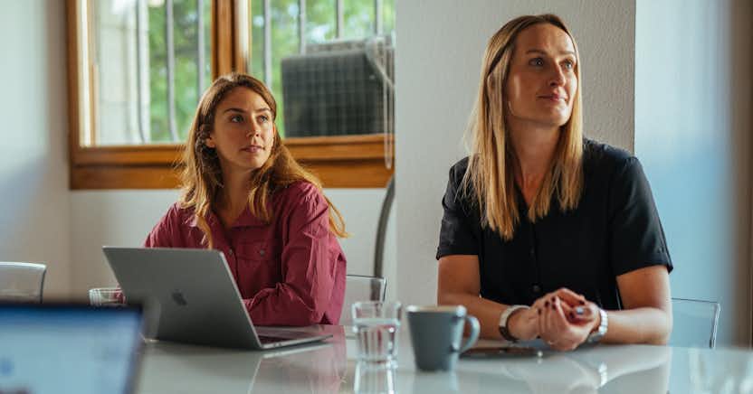 Two women at a table with laptop computer