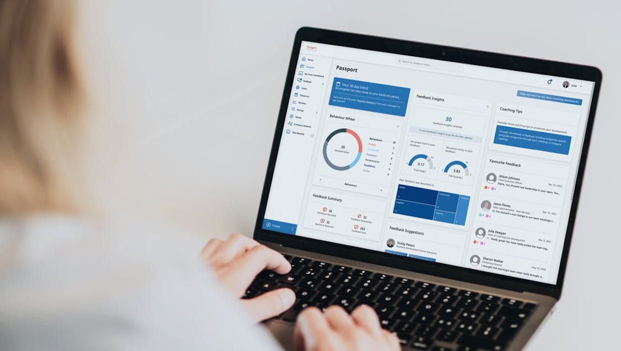 Someone looking at a laptop with charts and graphs on it