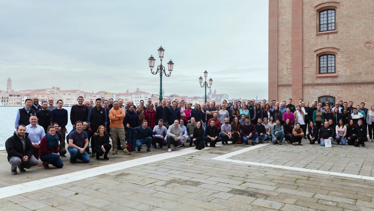 Large group of employees posing for a photo outdoors