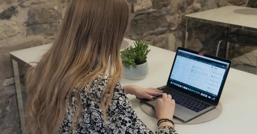 Woman typing on notebook computer