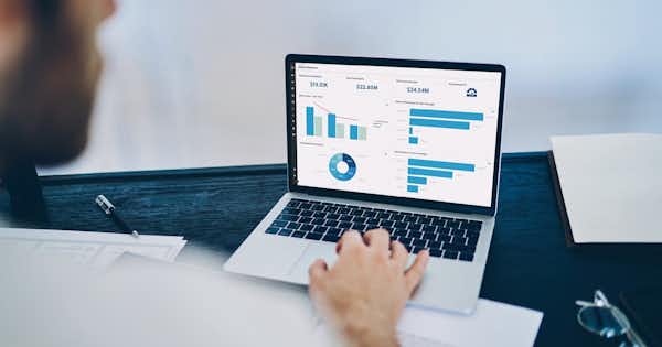 Man typing on laptop keyboard