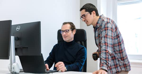 Two men looking at a computer screen