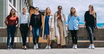 Groupe de sept femmes debout ensemble à l'extérieur